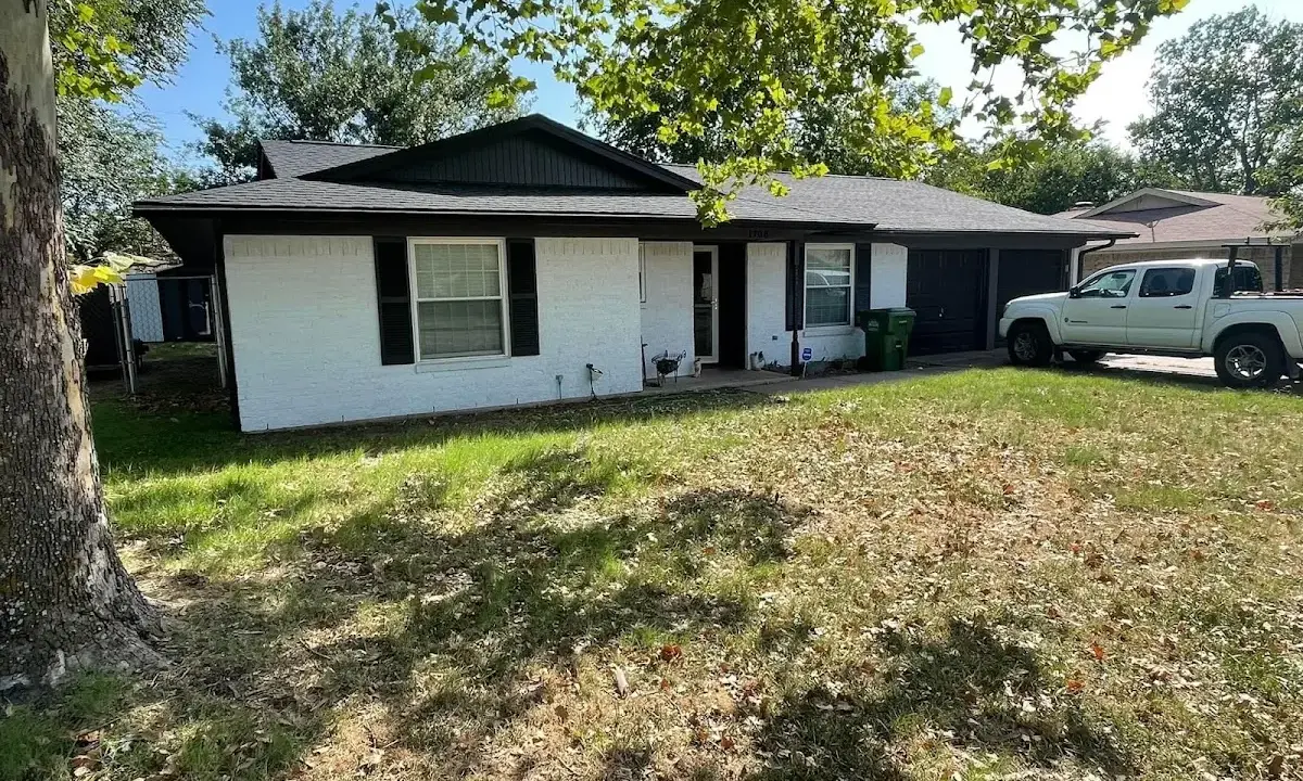 Professional roofing crew working on a residential roof in Paw Paw